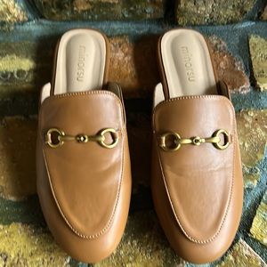 Minorsu tan colored mules.